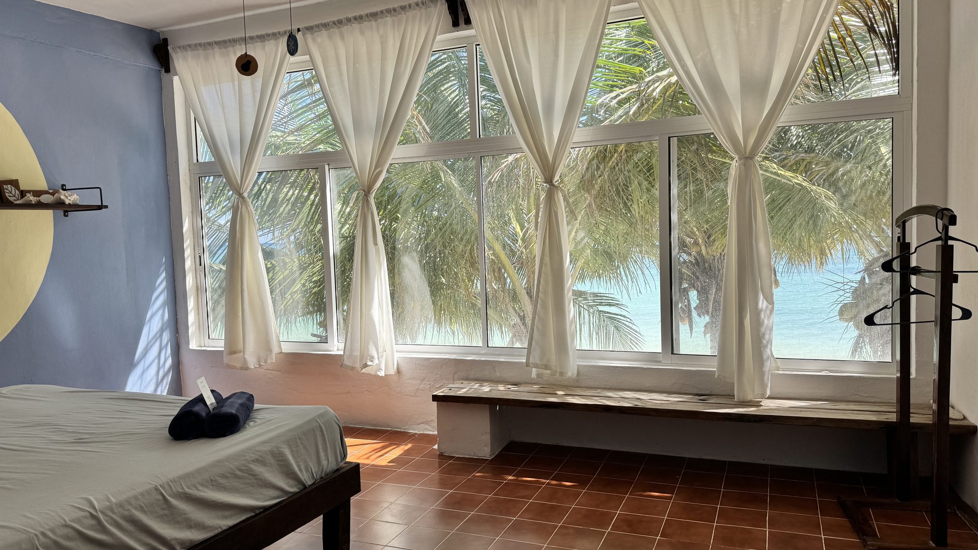 Room Sun — king bed, arched windows, sea and palms view